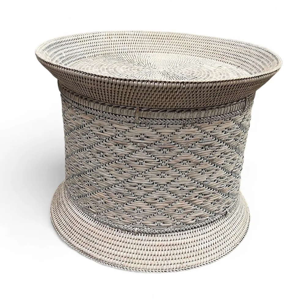 Round side table with a patterned woven top