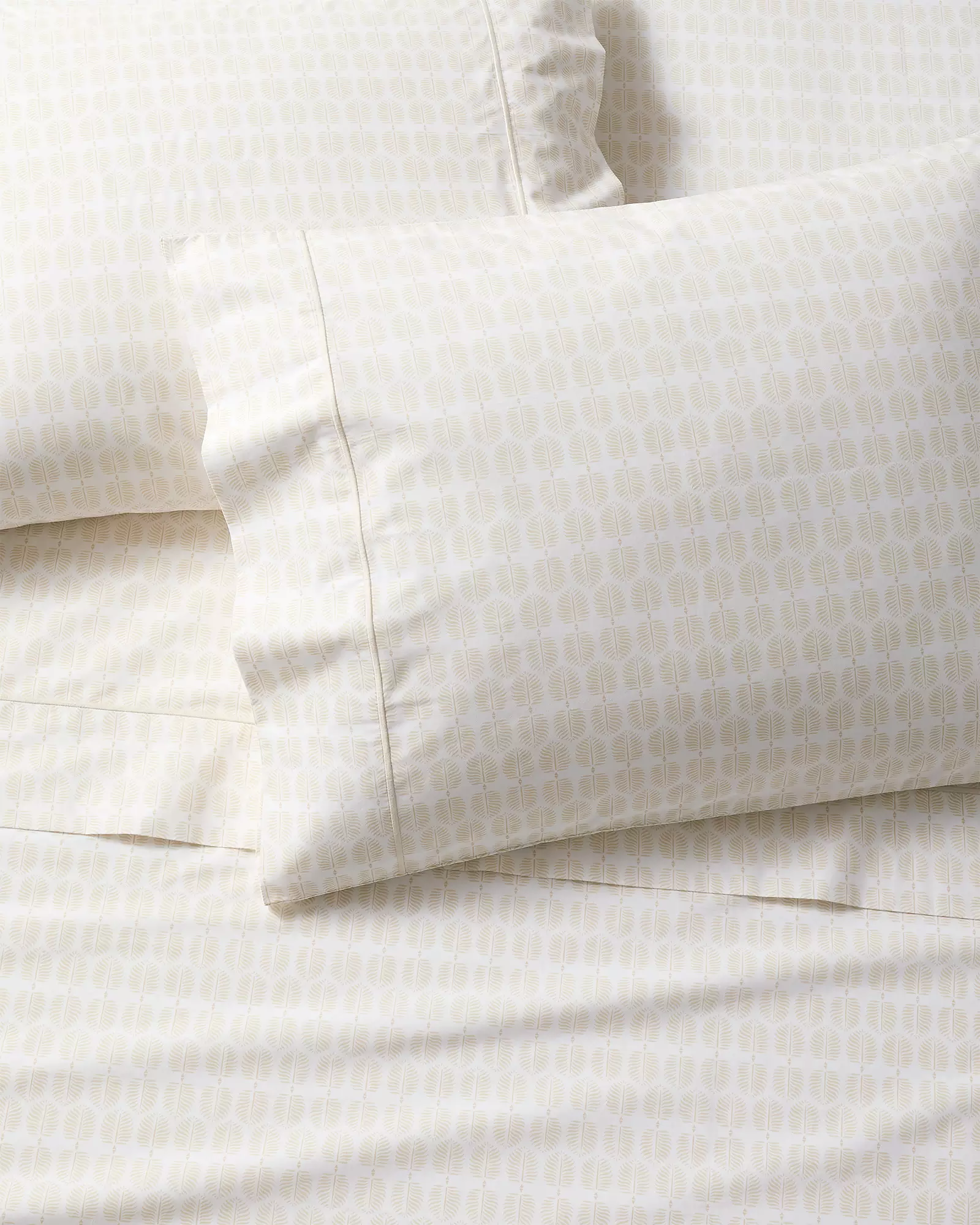 Cream percale sheets and pillowcases with a small repeating leaf print